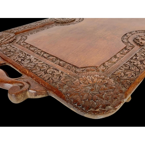 225 - A vintage carved Indian teak serving tray. 64 x 38cm.