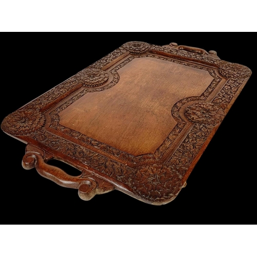 225 - A vintage carved Indian teak serving tray. 64 x 38cm.