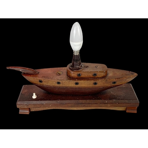 227 - A 1950’s teak lamp in the style of a boat. 35cm