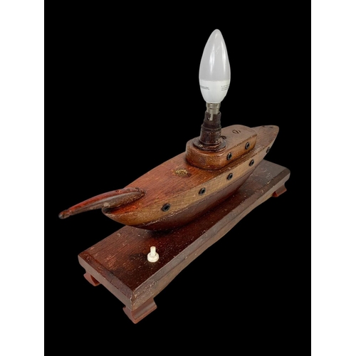 227 - A 1950’s teak lamp in the style of a boat. 35cm