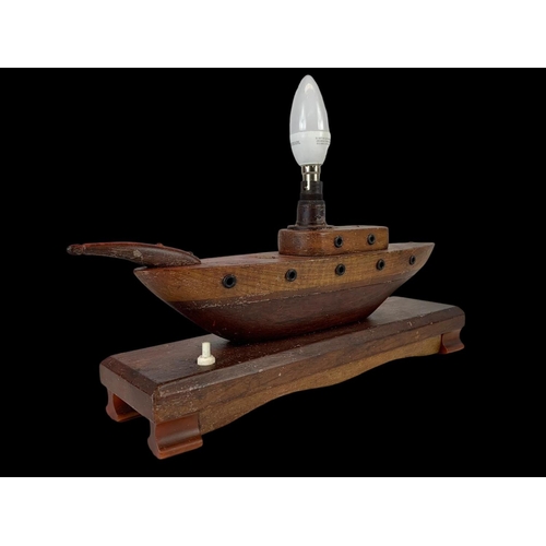 227 - A 1950’s teak lamp in the style of a boat. 35cm