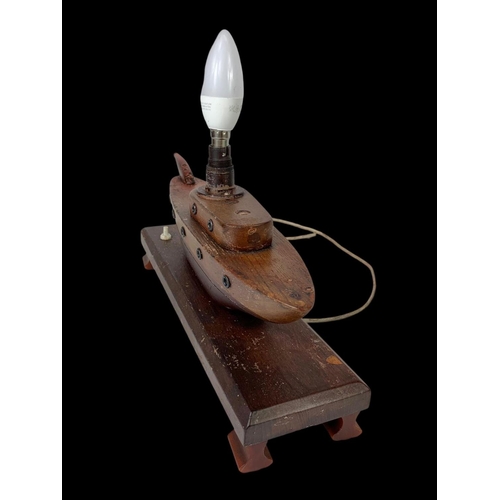 227 - A 1950’s teak lamp in the style of a boat. 35cm