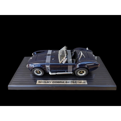 236 - 5 model cars on stands, largest stand measures 35cm