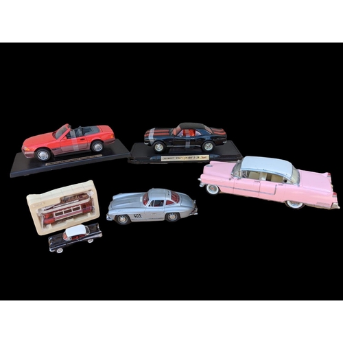 237 - 6 model cars etc, largest stand measures 35cm