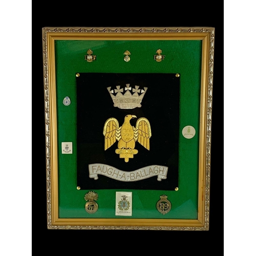 308 - A Royal Irish Fusiliers silk embroidery with old and new badges. Frame measures 47 x 57cm