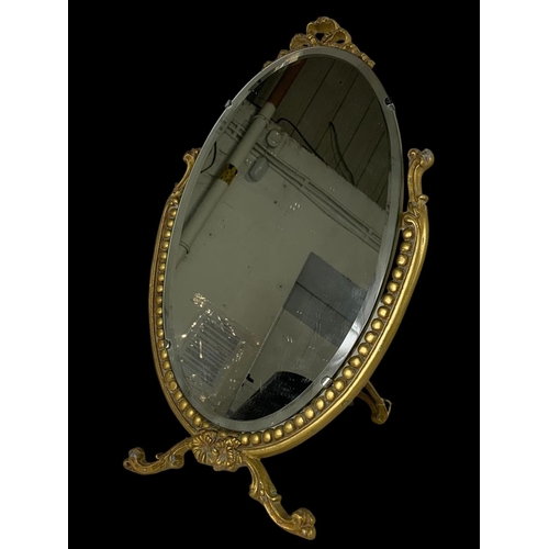 317 - An ornate gilt dressing mirror. 37 x 58cm