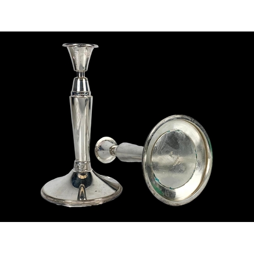 605 - A pair of Walker & Hall silver plated candlesticks, 21cm