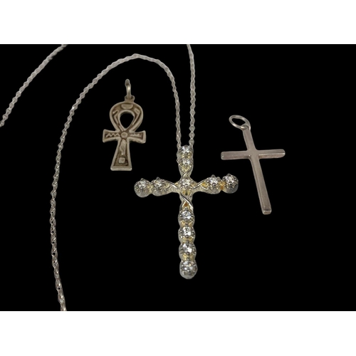 672 - 3 silver cross necklaces.