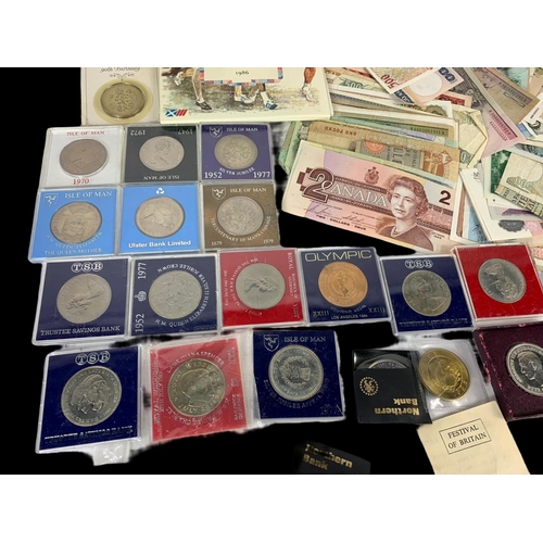 702 - A collection of British and foreign notes and coins.