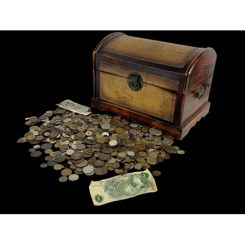 715 - A large quantity of British and foreign coins in a wooden trunk. Trunk measures 35 x 22 x 25cm.