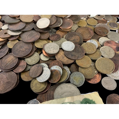 715 - A large quantity of British and foreign coins in a wooden trunk. Trunk measures 35 x 22 x 25cm.