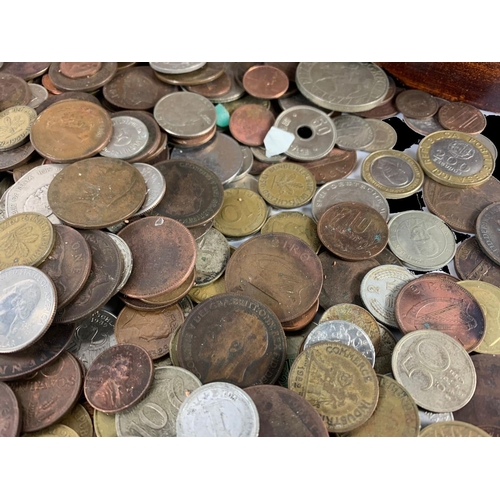 715 - A large quantity of British and foreign coins in a wooden trunk. Trunk measures 35 x 22 x 25cm.