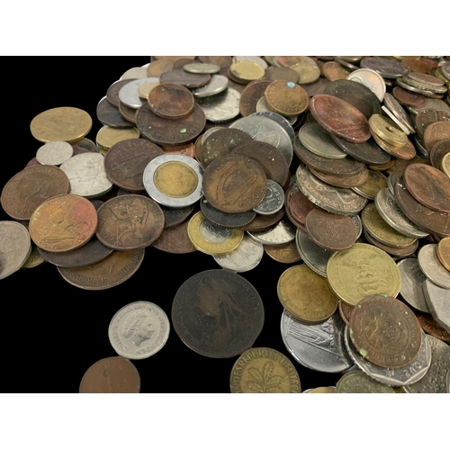 715 - A large quantity of British and foreign coins in a wooden trunk. Trunk measures 35 x 22 x 25cm.