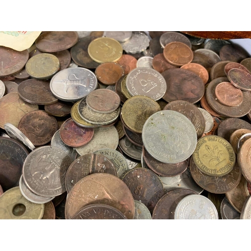 715 - A large quantity of British and foreign coins in a wooden trunk. Trunk measures 35 x 22 x 25cm.