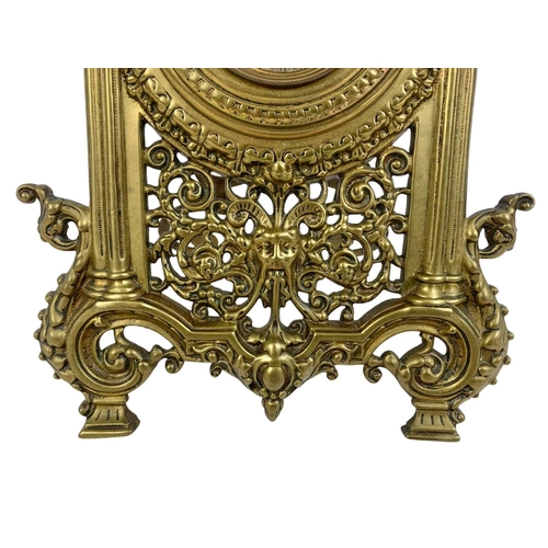 349 - A Victorian brass embossed mantle clock with silvered dial. 32cm.