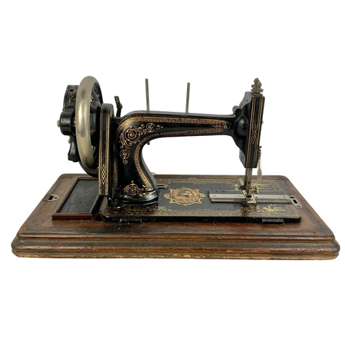 340d - A late Victorian hand turning sewing machine in an inlaid case. With Leo The Lion. Circa 1890/1900. ... 