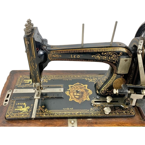 340d - A late Victorian hand turning sewing machine in an inlaid case. With Leo The Lion. Circa 1890/1900. ... 