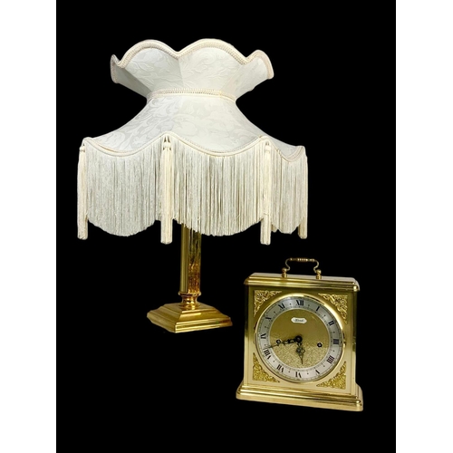 362 - A large brass mantle clock by Hermle and a brass lamp. Clock measures 25 x 29.5cm.