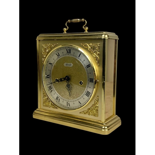 362 - A large brass mantle clock by Hermle and a brass lamp. Clock measures 25 x 29.5cm.