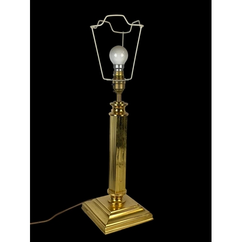 362 - A large brass mantle clock by Hermle and a brass lamp. Clock measures 25 x 29.5cm.