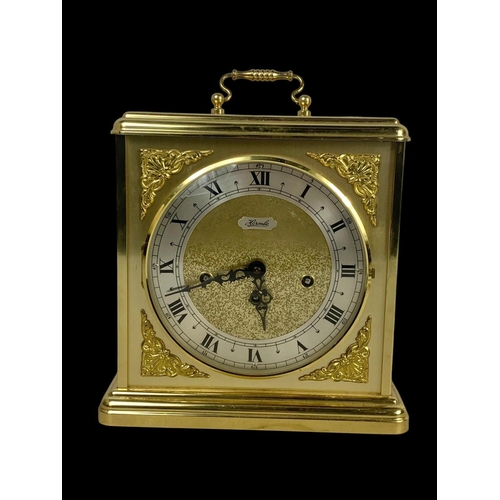 362 - A large brass mantle clock by Hermle and a brass lamp. Clock measures 25 x 29.5cm.