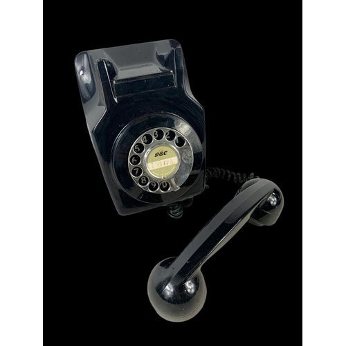 384 - A vintage wall mounted telephone.