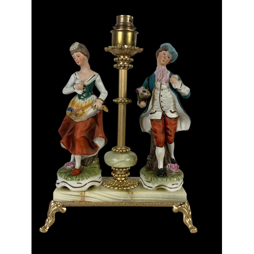 644 - A brass and onyx lamp with porcelain figures. Base measures 21 x 10 x 28.5cm.