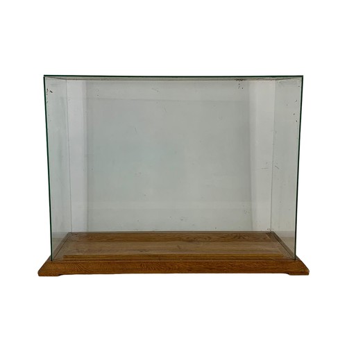 208f - A large glass display case on an oak base. 94 x 44 x 68cm