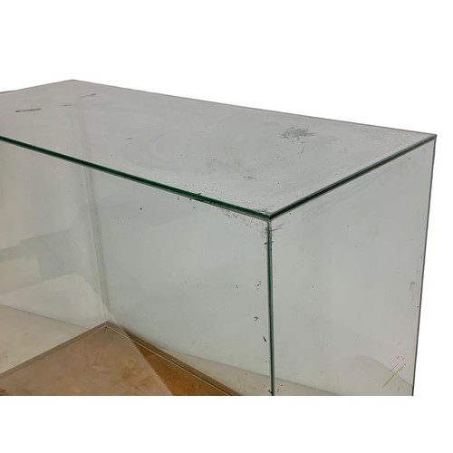 208f - A large glass display case on an oak base. 94 x 44 x 68cm