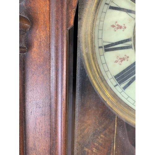 208h - A large Victorian Vienna wall clock with weights and pendulum 47x97cm.