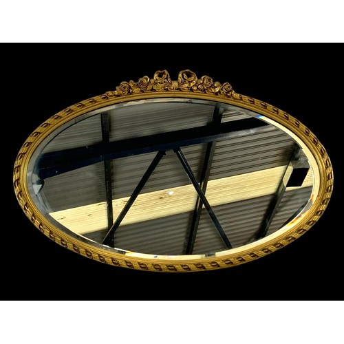 740 - An ornate gilt framed mirror.  72x47.5cm