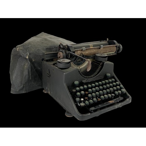 306i - An early 20th century cast iron type writer by Bar-Lock. 29 x 36cm.