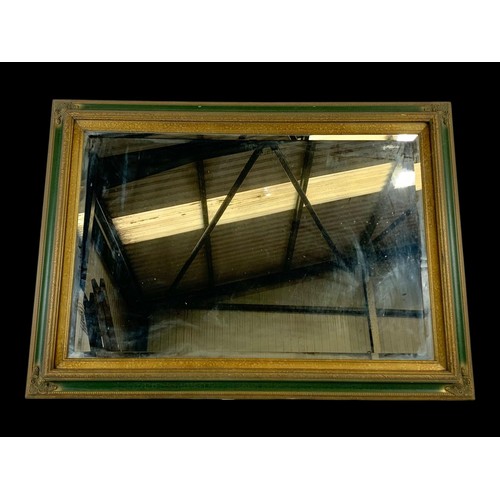 1174 - A large ornate framed mirror. 109 x 78.5cm.