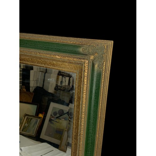 1174 - A large ornate framed mirror. 109 x 78.5cm.