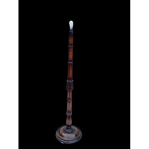 1179 - A vintage carved mahogany standard lamp. 155cm