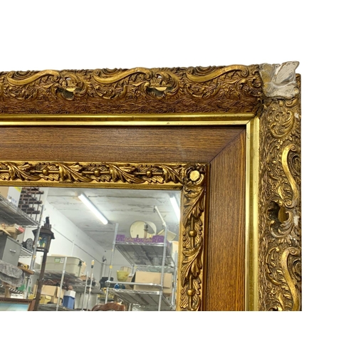 290 - A Victorian ornate gilt framed mirror. 87.5 x 77.5cm.