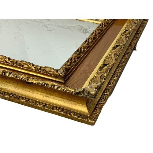 290 - A Victorian ornate gilt framed mirror. 87.5 x 77.5cm.