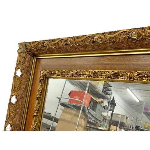 290 - A Victorian ornate gilt framed mirror. 87.5 x 77.5cm.