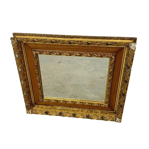 290 - A Victorian ornate gilt framed mirror. 87.5 x 77.5cm.