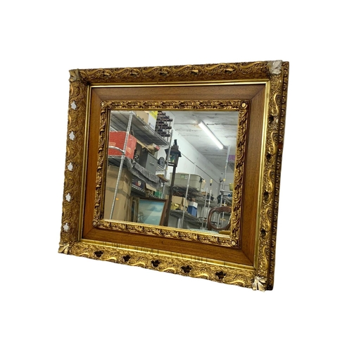 290 - A Victorian ornate gilt framed mirror. 87.5 x 77.5cm.