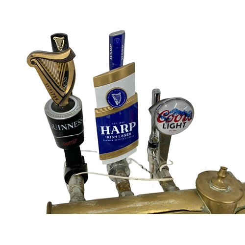 293 - A large vintage heavy brass beer pump/draft. Guinness, Harp, Coors Light. 83 x 77cm.