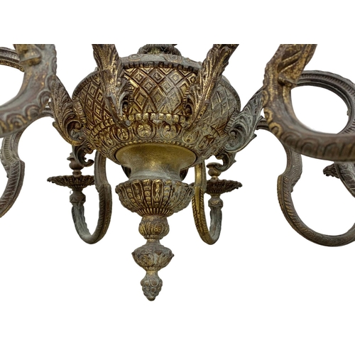 295 - A large vintage ornate heavy brass chandelier. 78 x 111cm.