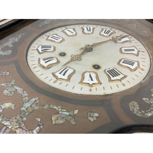 297 - A 19th century French wall clock with mother of pearl inlay. 47 x 62cm.