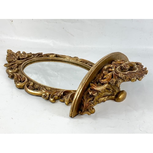 153 - A gilt framed mirror with shelf, 61cm x 37cm