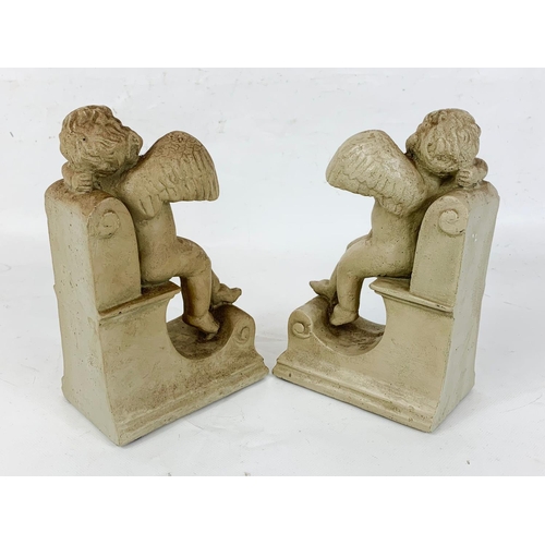 168 - A pair of heavy cherub bookends, 21cm