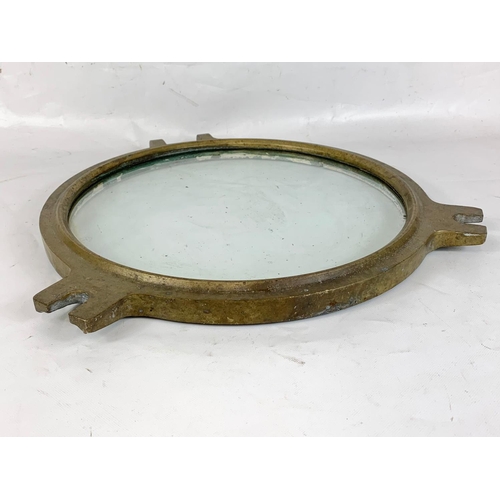 170 - A vintage heavy brass ship's porthole, 51cm