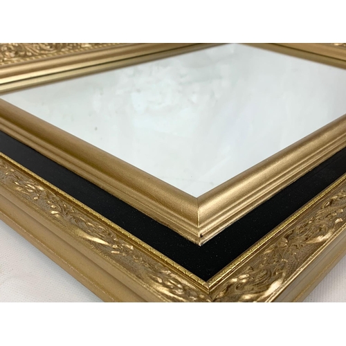 171 - An ornate gilt framed mirror, 67cm x 48cm