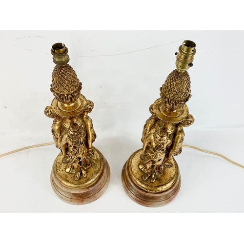 192 - A pair of vintage gilt lamps on a marble base.  50cm