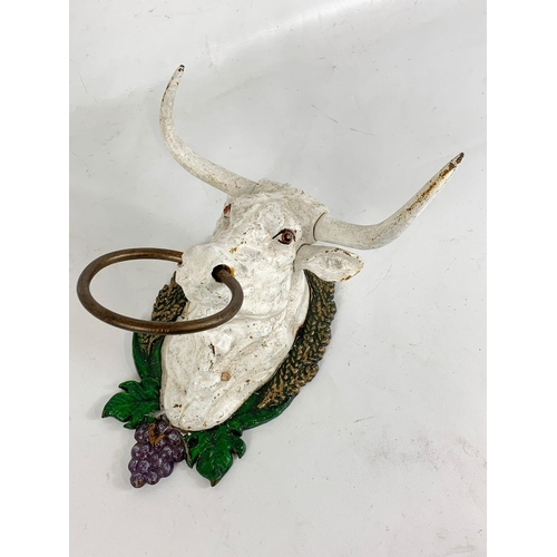 194 - A cast iron bull head.  17cm