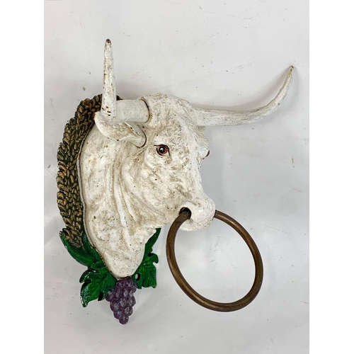 195 - A cast iron bull head.  17cm